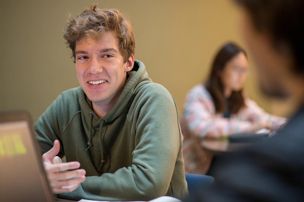 Student studies in the Min H. Kao building commons area | Min H. Kao