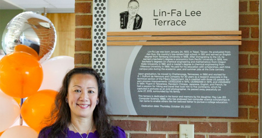 May Lee stands beside Lin-Fa Lee Terrace plaque