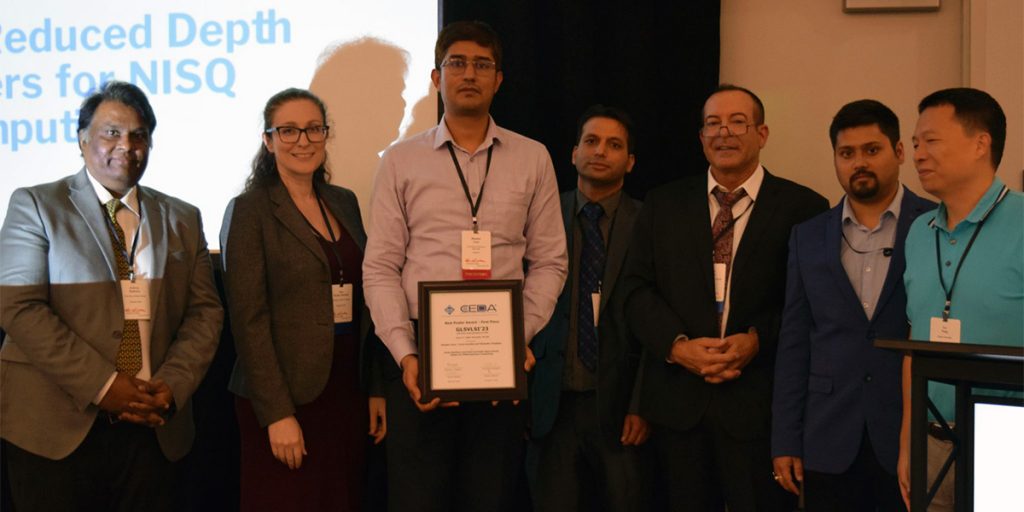 EECS Associate Professor Himanshu Thapliyal, PhD student Bhaskar Gaur, and the other members of their research group present the award they received at the GLSVLSI conference.