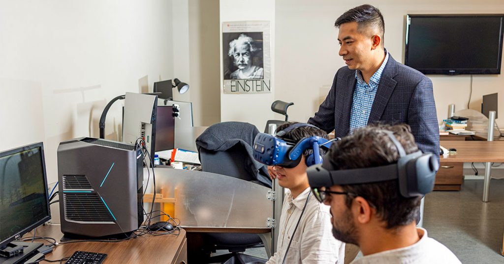 Jian Liu and grad students using VR headsets