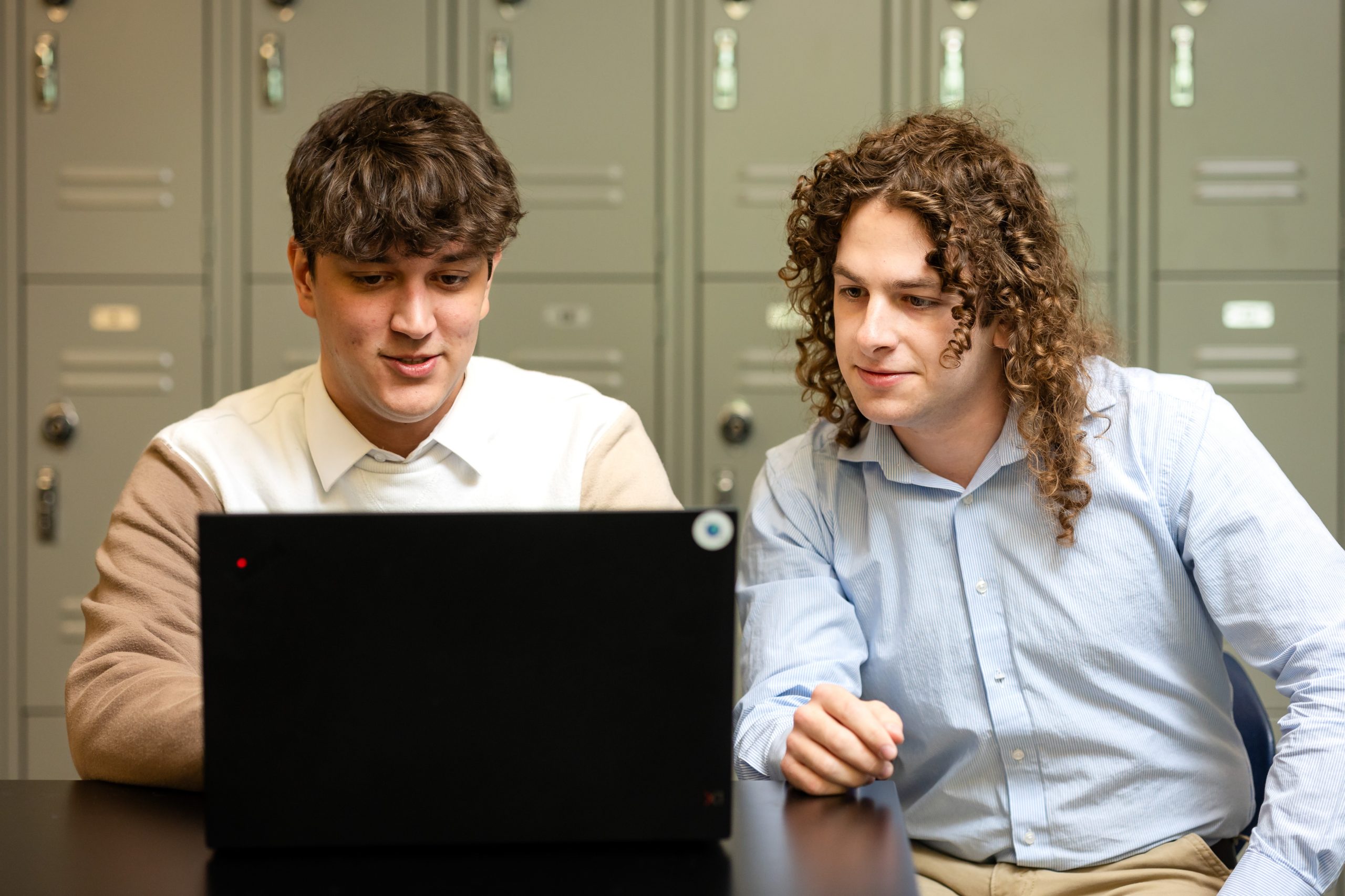 Zavier Miller and Andrew Rutter working on a computer